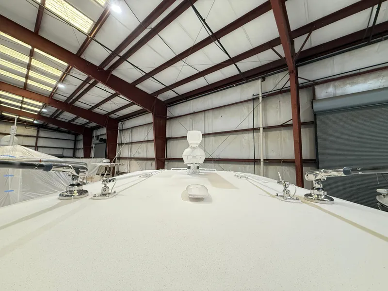 Slide: The Image of 2022 Invincible 39 Open Fisherman boat in a warehouse, viewed from the bow. - 33