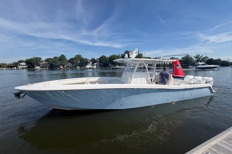 Slide: The Image of 2022 Invincible 39 Open Fisherman boat on calm water, under a clear blue sky. - 4