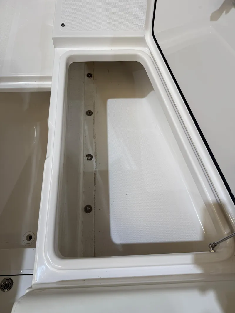 Slide: The Image of 2022 Invincible 39 Open Fisherman storage compartment, white interior, open lid. - 40