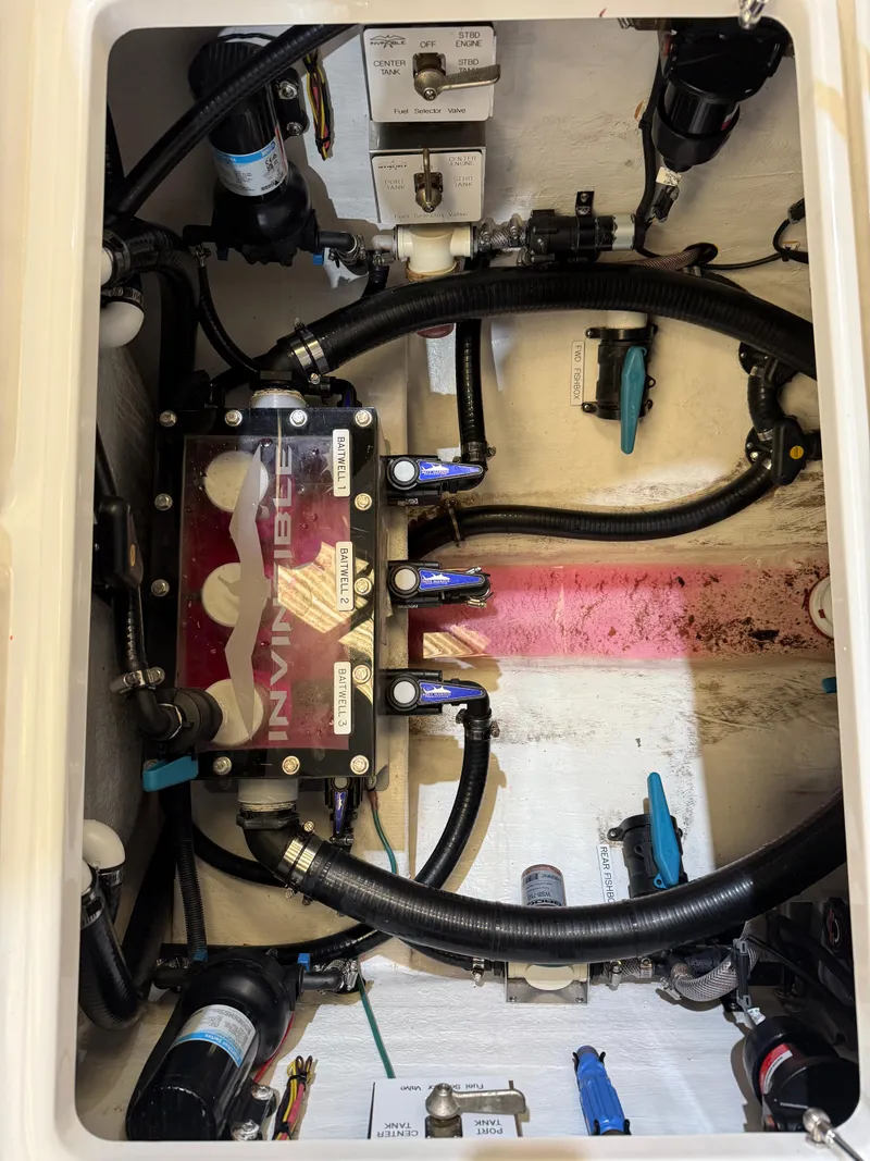 Slide: The Image of 2022 Invincible 39 Open Fisherman boat engine compartment with hoses and components. - 42