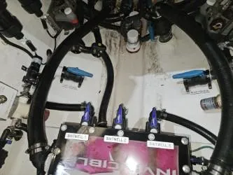 Slide: The Image of Engine compartment of a 2022 Invincible 39 Open Fisherman boat, showing hoses and valves. - 47