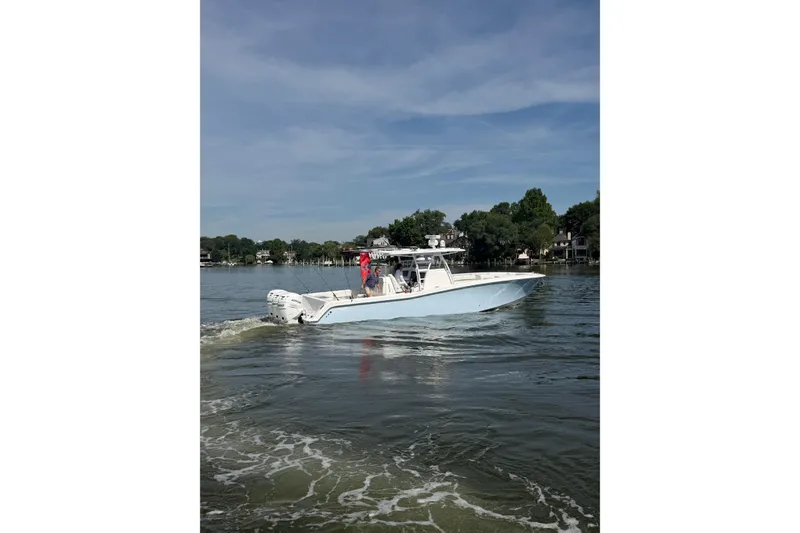 Slide: The Image of 2022 Invincible 39 Open Fisherman boat cruising on a calm lake. - 5