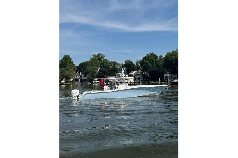 Slide: The Image of 2022 Invincible 39 Open Fisherman boat cruising on a calm lake. - 7