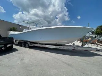 Slide: The Image of 2022 Invincible 39 Open Fisherman boat on trailer under cloudy sky. - 8
