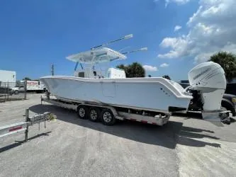 Slide: The Image of 2022 Invincible 39 Open Fisherman boat on trailer under blue sky. - 9