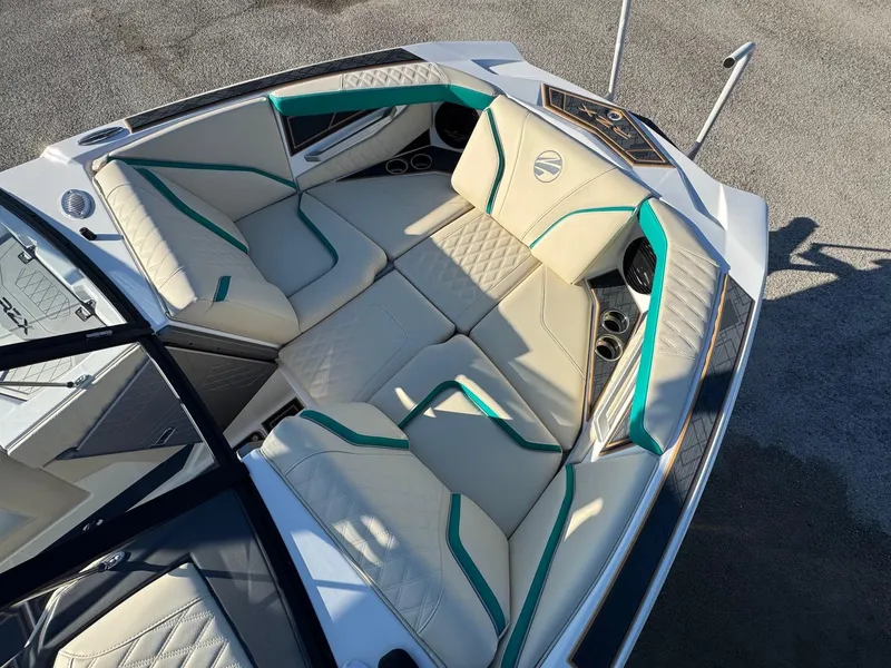 Slide: The Image of Luxurious interior of 2025 Tigé 22RZX boat with beige and teal seating. - 11