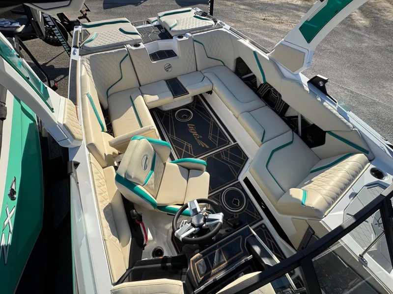 Slide: The Image of 2025 Tigé 22RZX boat interior with beige and teal seating, modern dashboard, and spacious layout. - 12