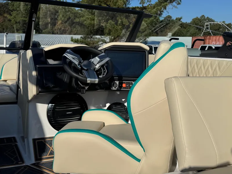 Slide: The Image of 2025 Tigé 22RZX boat interior with beige seats and modern dashboard. - 8