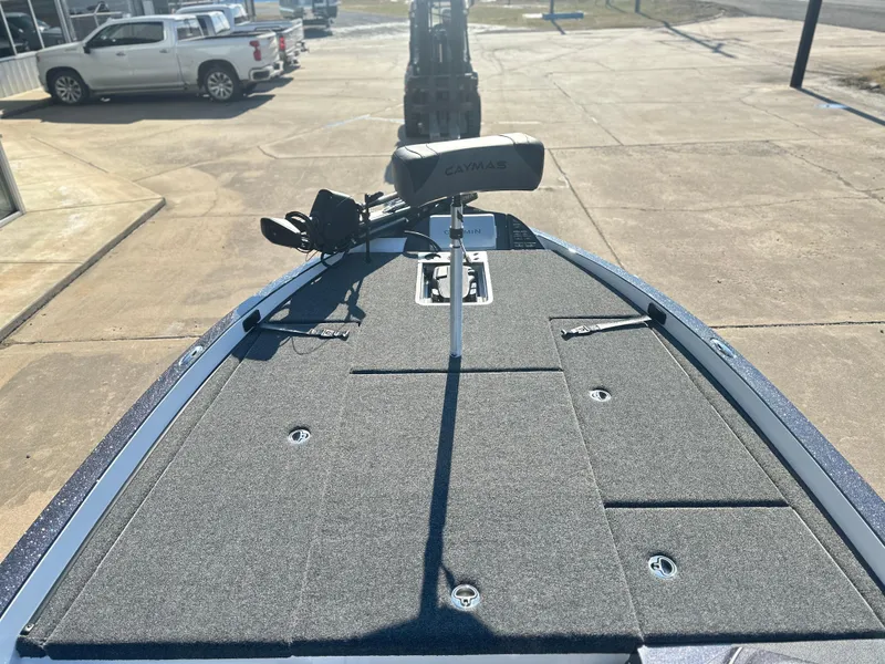 Slide: The Image of 2025 Caymas CX 20 PRO boat deck with trolling motor in a parking lot. - 6