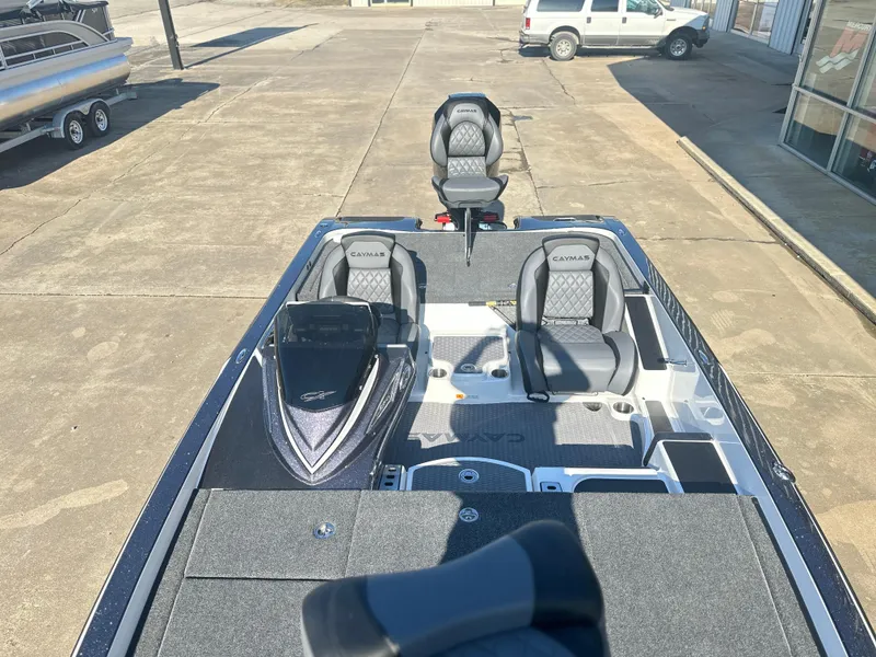 Slide: The Image of 2025 Caymas CX 20 PRO boat with dual seats and spacious deck in a parking lot. - 8