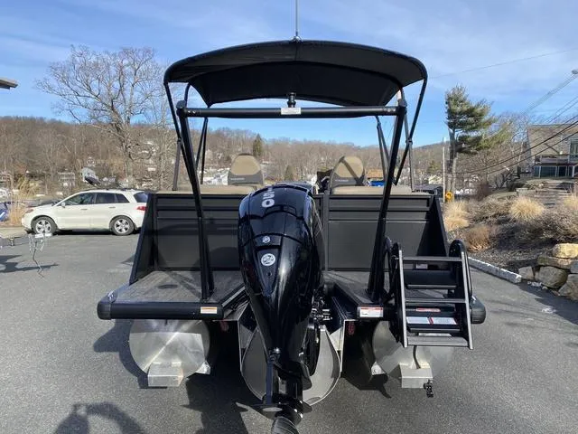 Slide: The Image of 2025 Viaggio x20u pontoon boat with outboard motor, parked outdoors. - 4