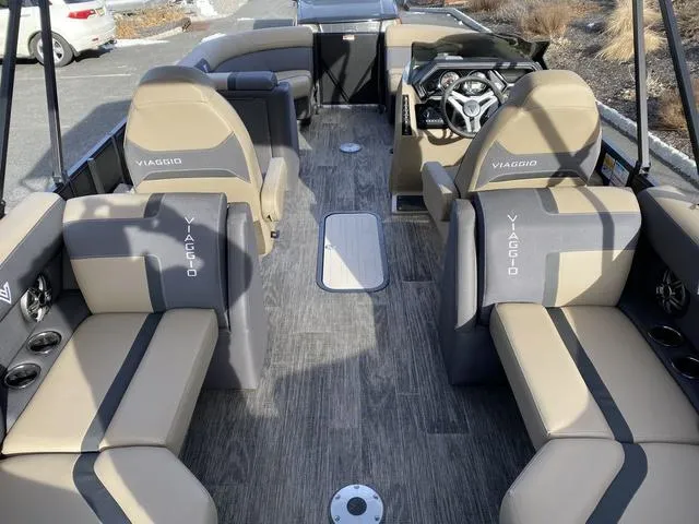Slide: The Image of Viaggio x20u 2025 boat interior with beige and gray seating, modern steering console. - 9