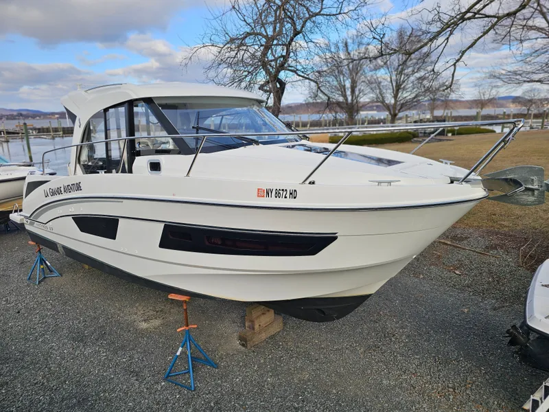 Slide: The Image of 2020 Beneteau Antares 9 boat on stands, outdoor setting, cloudy sky. - 0