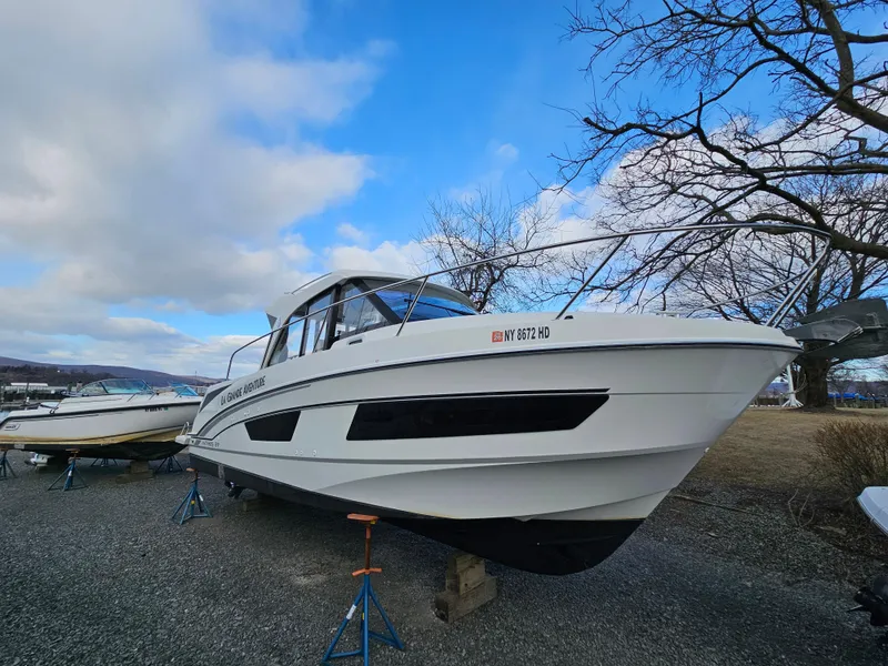 Slide: The Image of 2020 Beneteau Antares 9 boat on stands, outdoors under a blue sky. - 1
