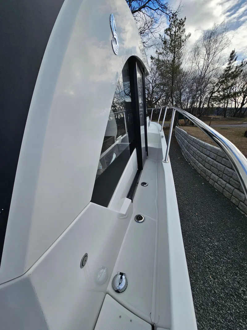 Slide: The Image of 2020 Beneteau Antares 9 boat exterior with sleek design and railing. - 13