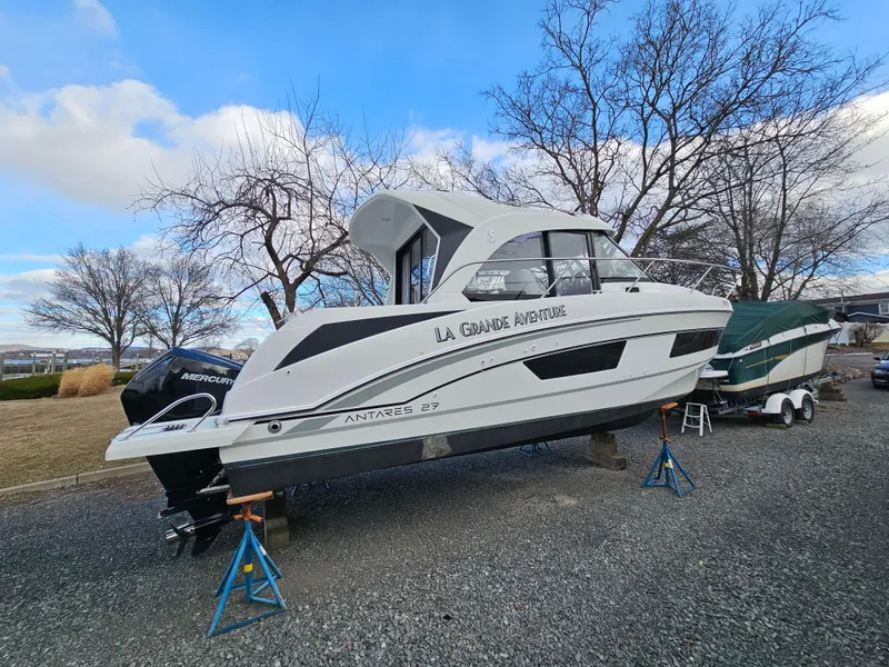 Slide: The Image of 2020 Beneteau Antares 9 boat on stands, outdoors, under a blue sky. - 3