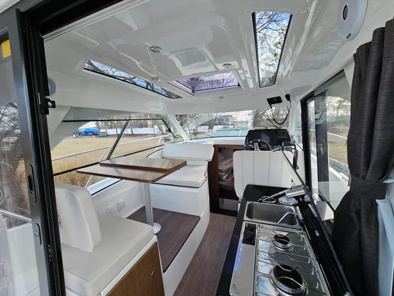 Slide: The Image of Interior of 2020 Beneteau Antares 9 boat with seating, table, and kitchenette. - 4