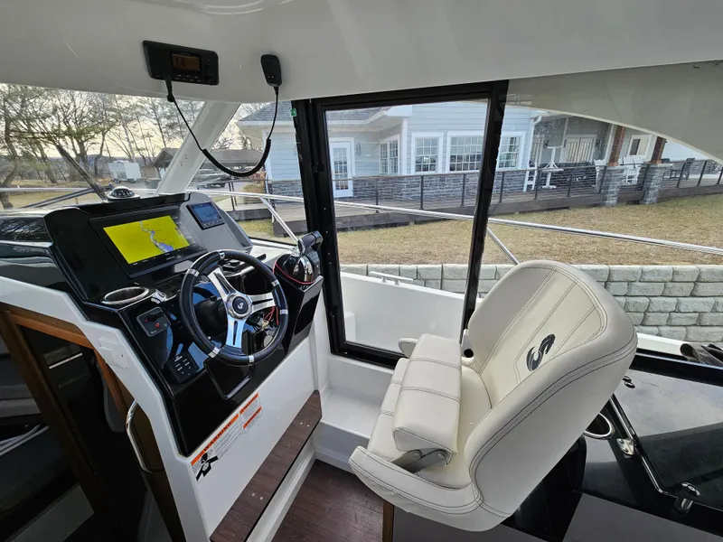 Slide: The Image of 2020 Beneteau Antares 9 helm with modern controls and comfortable seating. - 7