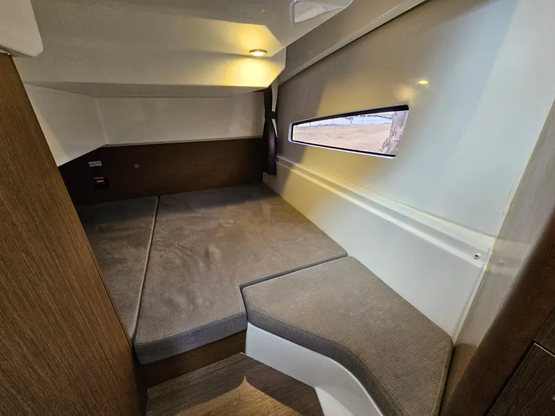 Slide: The Image of 2020 Beneteau Antares 9 cabin interior with cozy bed and window view. - 9