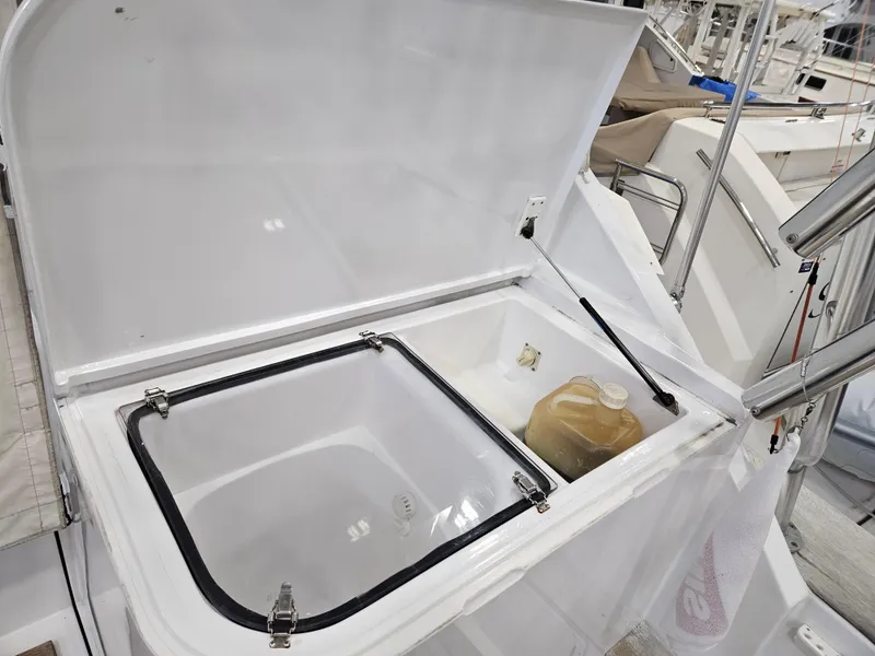 Slide: The Image of Open storage compartment on 2001 Davis 45 Express boat with a container inside. - 10