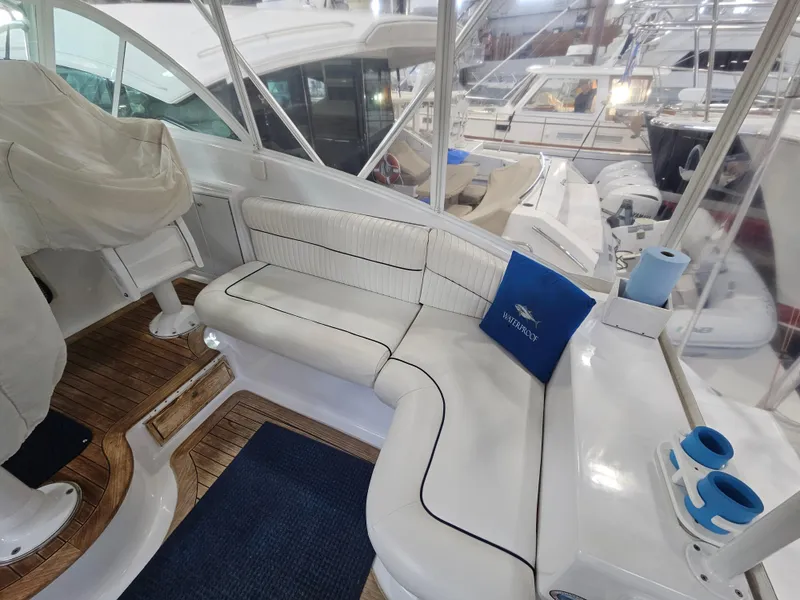 Slide: The Image of Interior of 2001 Davis 45 Express yacht with white seating and wooden flooring. - 11