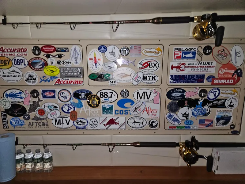 Slide: The Image of Wall of fishing stickers and rods on a 2001 Davis 45 Express boat. - 15
