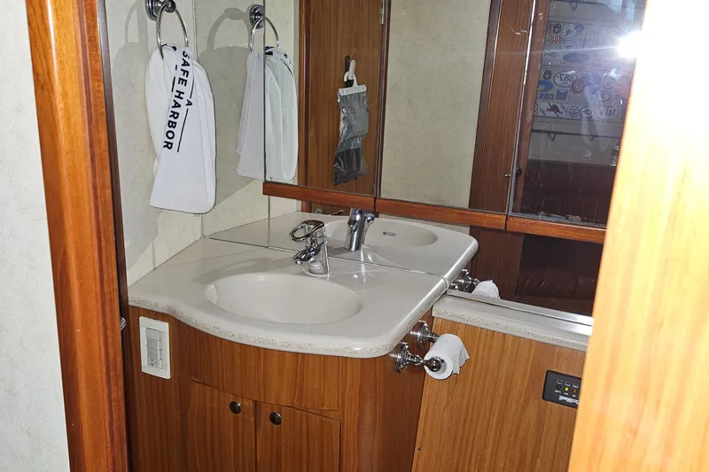 Slide: The Image of Bathroom interior of 2001 Davis 45 Express yacht with dual sinks and wooden cabinetry. - 16