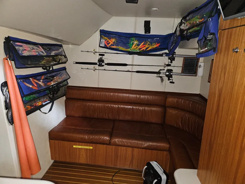 Slide: The Image of Interior of 2001 Davis 45 Express boat with fishing rods and leather seating. - 17