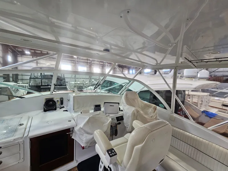Slide: The Image of Interior view of a 2001 Davis 45 Express yacht, showcasing helm and seating area. - 4