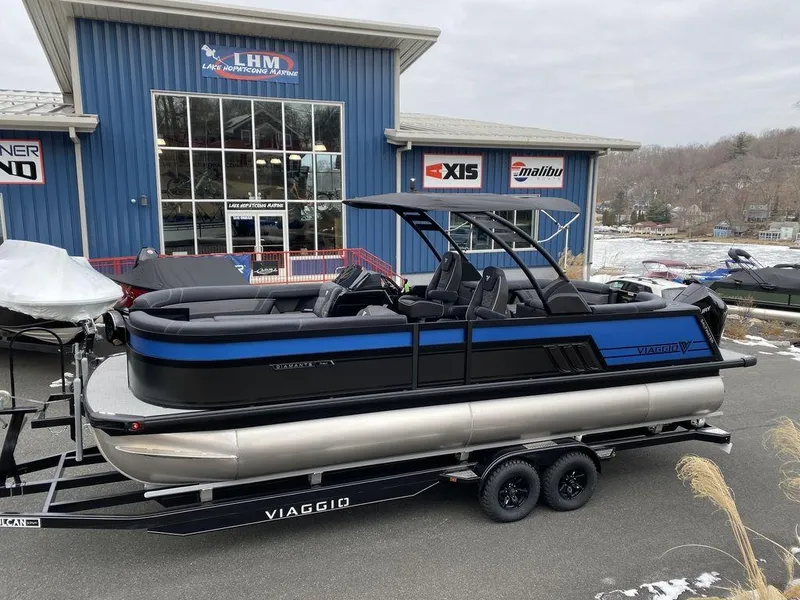 The Image of 2025 Viaggio D24U pontoon boat on trailer outside dealership. - 1