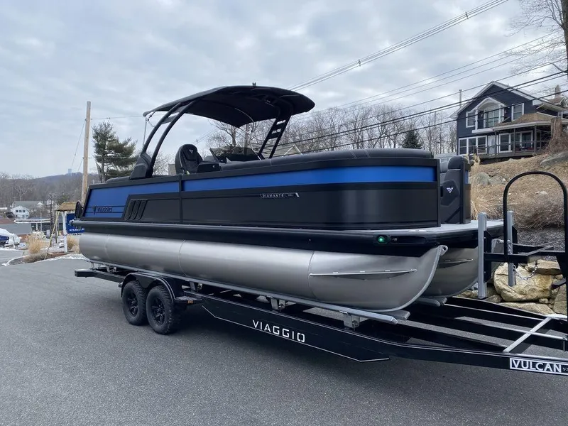 Slide: The Image of 2025 Viaggio D24U pontoon boat on trailer, parked on a road. - 4