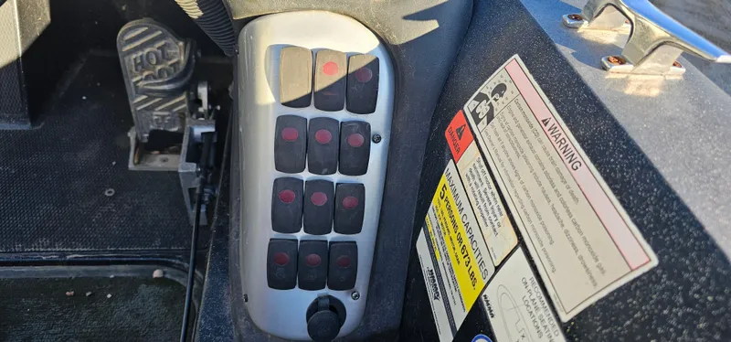 Slide: The Image of Control panel and warning labels in a 2009 Stratos 201 XL boat. - 14