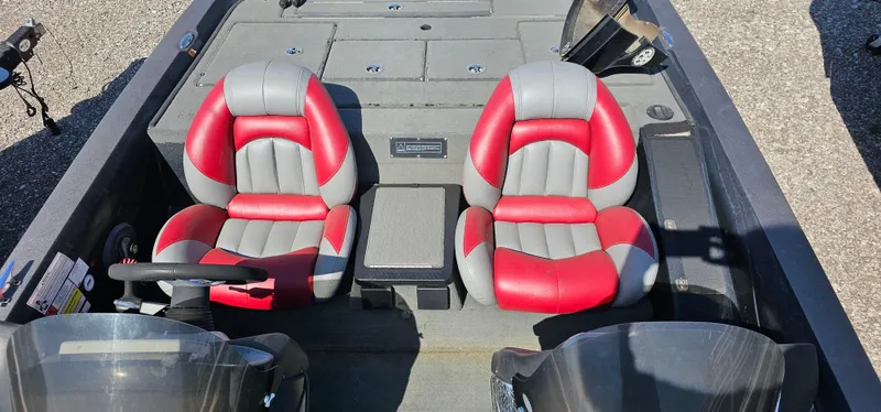 Slide: The Image of 2009 Stratos 201 XL boat interior with red and gray seats, steering wheel visible. - 21