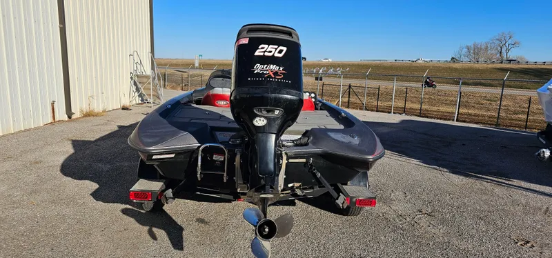 Slide: The Image of 2009 Stratos 201 XL boat with 250 HP motor, parked outdoors. - 3