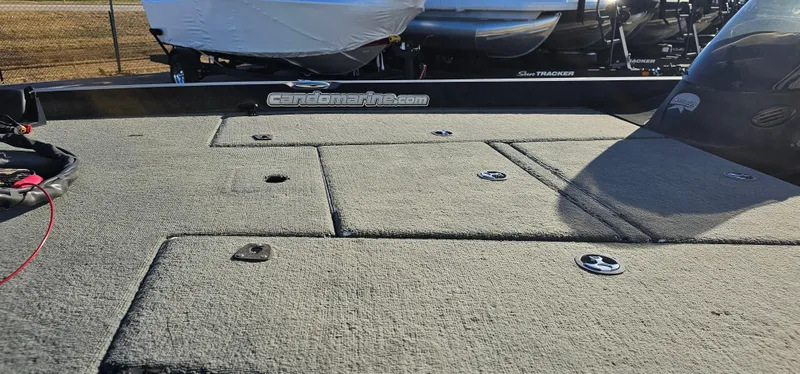 Slide: The Image of 2009 Stratos 201 XL boat deck with storage compartments and carpeted surface. - 8