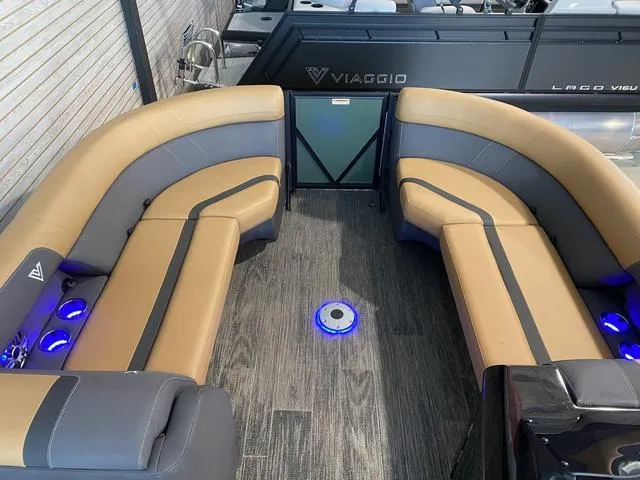 Slide: The Image of Luxurious 2025 Viaggio X22S boat interior with tan and gray seating, blue LED lights. - 10