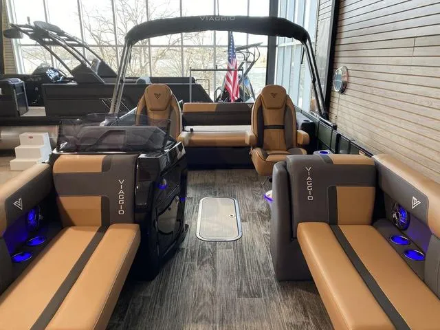 Slide: The Image of 2025 Viaggio X22S luxury boat interior with tan and gray seating, modern design. - 12