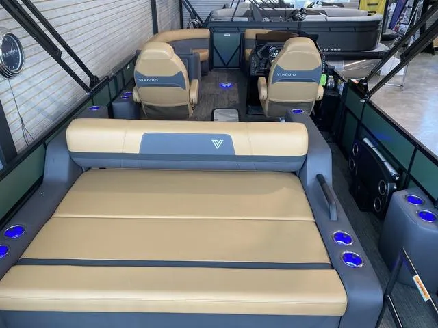 Slide: The Image of 2025 Viaggio X22S boat interior with tan seating and blue cup holders. - 4