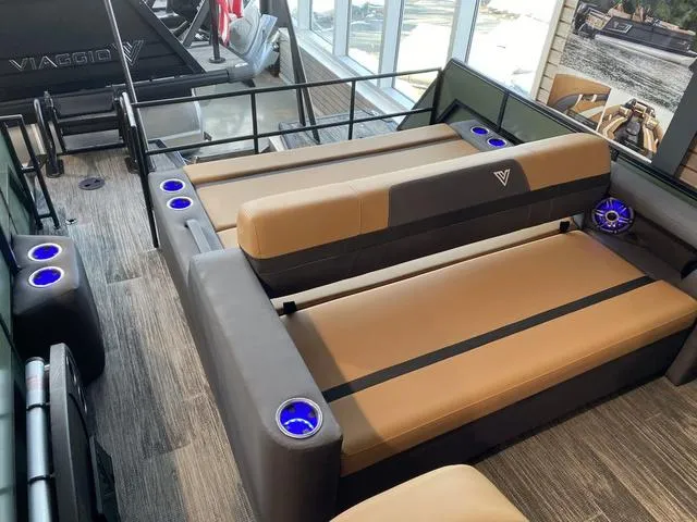 Slide: The Image of Luxurious Viaggio X22S 2025 boat interior with tan seating and blue LED cup holders. - 5