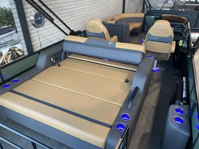 Slide: The Image of 2025 Viaggio X22S boat interior with tan seating and blue LED cup holders. - 6