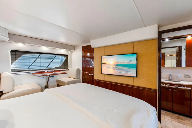 Slide: The Image of Luxurious 2009 Sea Ray 55 Sundancer yacht interior with modern bedroom and TV. - 11