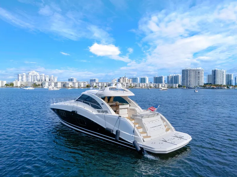 Slide: The Image of 2009 Sea Ray 55 Sundancer yacht cruising near city skyline on a sunny day. - 4