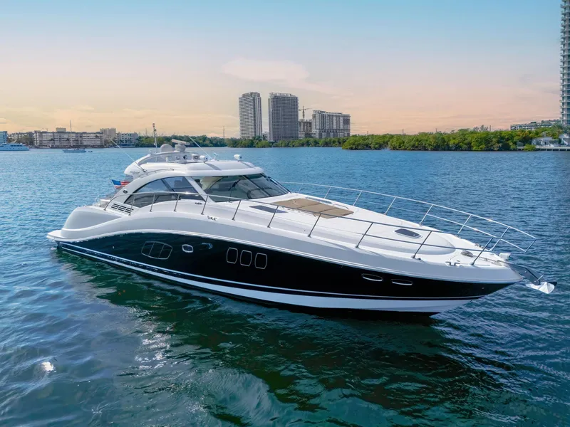 Slide: The Image of 2009 Sea Ray 55 Sundancer yacht cruising on a calm blue waterway. - 5