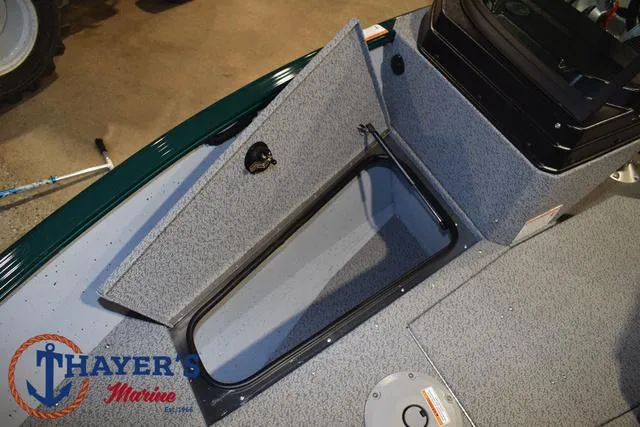 Slide: The Image of 2025 Lund 1675 Adventure Sport boat storage compartment, Thayer's Marine logo visible. - 13