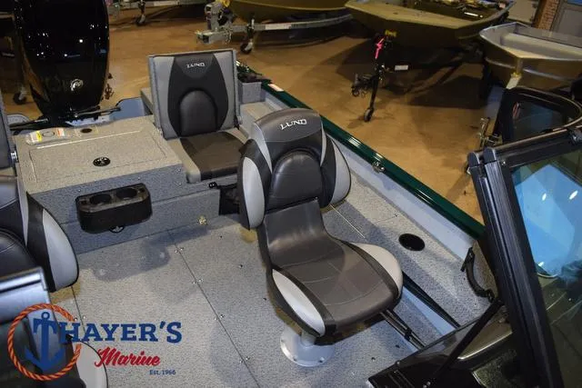 Slide: The Image of 2025 Lund 1675 Adventure Sport boat interior with seating at Thayer's Marine showroom. - 17