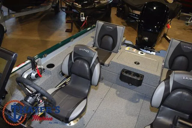 Slide: The Image of 2025 Lund 1675 Adventure Sport boat interior with seating and steering wheel. - 18