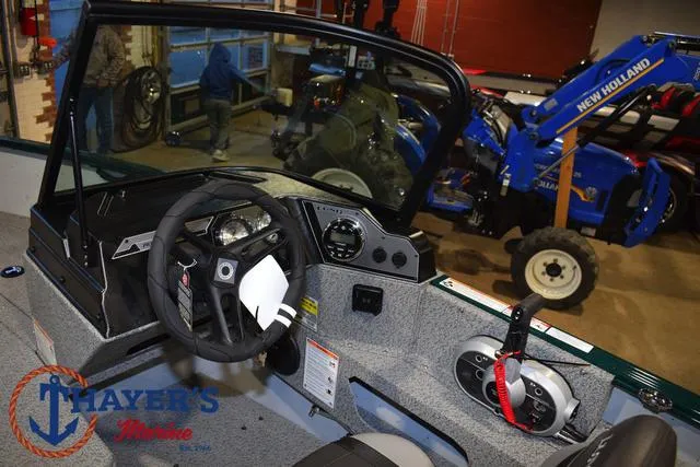 Slide: The Image of Interior of 2025 Lund 1675 Adventure Sport boat with steering wheel and controls. - 23