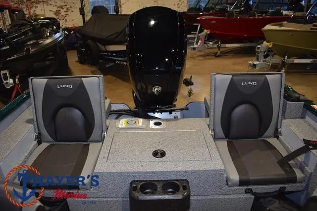 Slide: The Image of 2025 Lund 1675 Adventure Sport boat interior with dual seats and motor. - 27