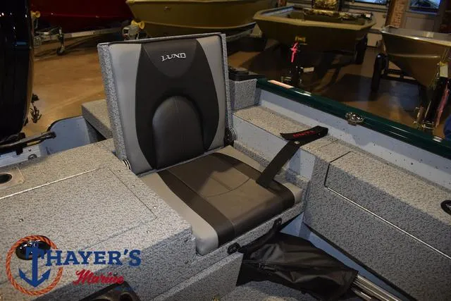 Slide: The Image of 2025 Lund 1675 Adventure Sport boat seat in showroom, featuring Thayer's Marine logo. - 28