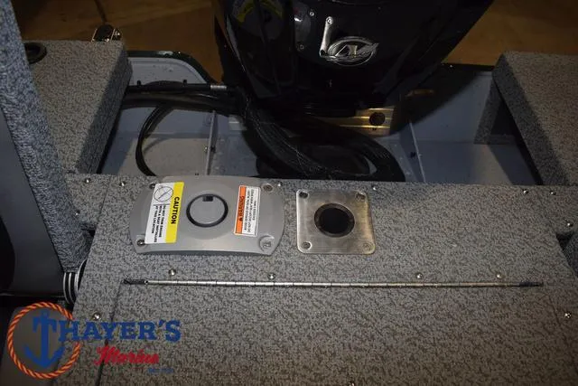 Slide: The Image of 2025 Lund 1675 Adventure Sport boat interior with motor and caution label. - 33